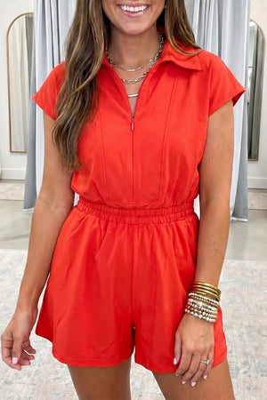 Red cotton romper with polo collar, zip front, short sleeves, and elastic waist.