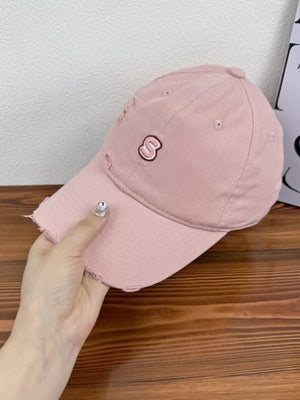 Pink distressed baseball cap with embroidered S logo