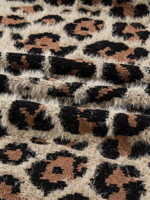 Leopard print fuzzy knit cardigan with textured details.
