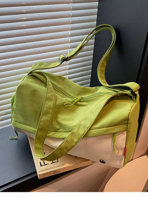 Vibrant color-block nylon travel bag with adjustable strap and zippered compartments.