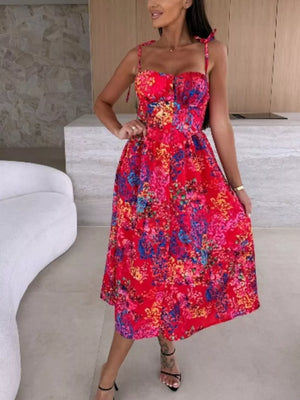 Floral tie-strap midi dress in vibrant red with multicolor floral print, sweetheart neckline, and A-line skirt.