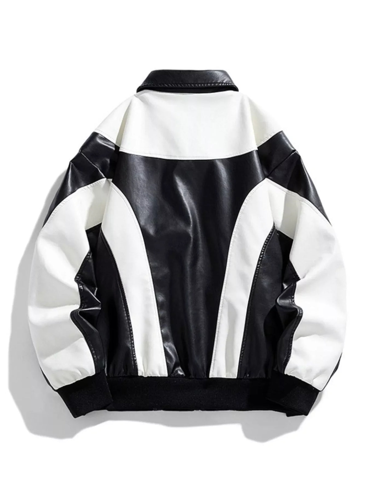 Retro bomber jacket in black and white faux leather with colorblock design and ribbed cuffs.