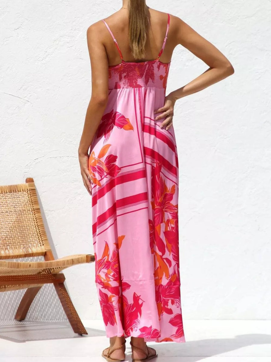 Maxi dress with spaghetti straps, smocked bodice, and floral print in pink and red.