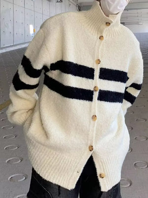 Striped knit cardigan in cream with black stripes, button-down front, and mock neck.