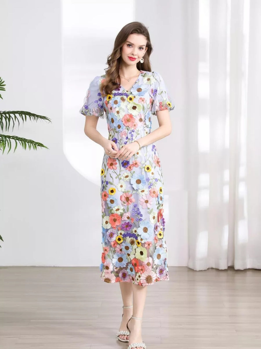 Sheath dress with multicolor floral embroidery, V-neck, short puff sleeves, and midi length.