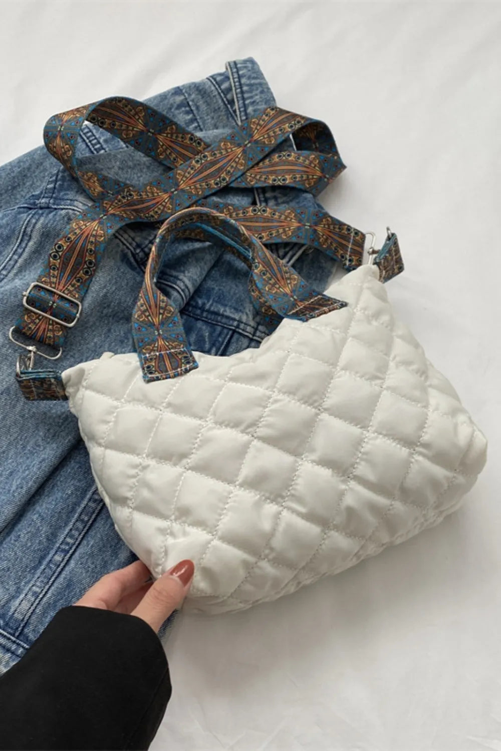 White quilted satchel bag with a patterned strap and denim detail