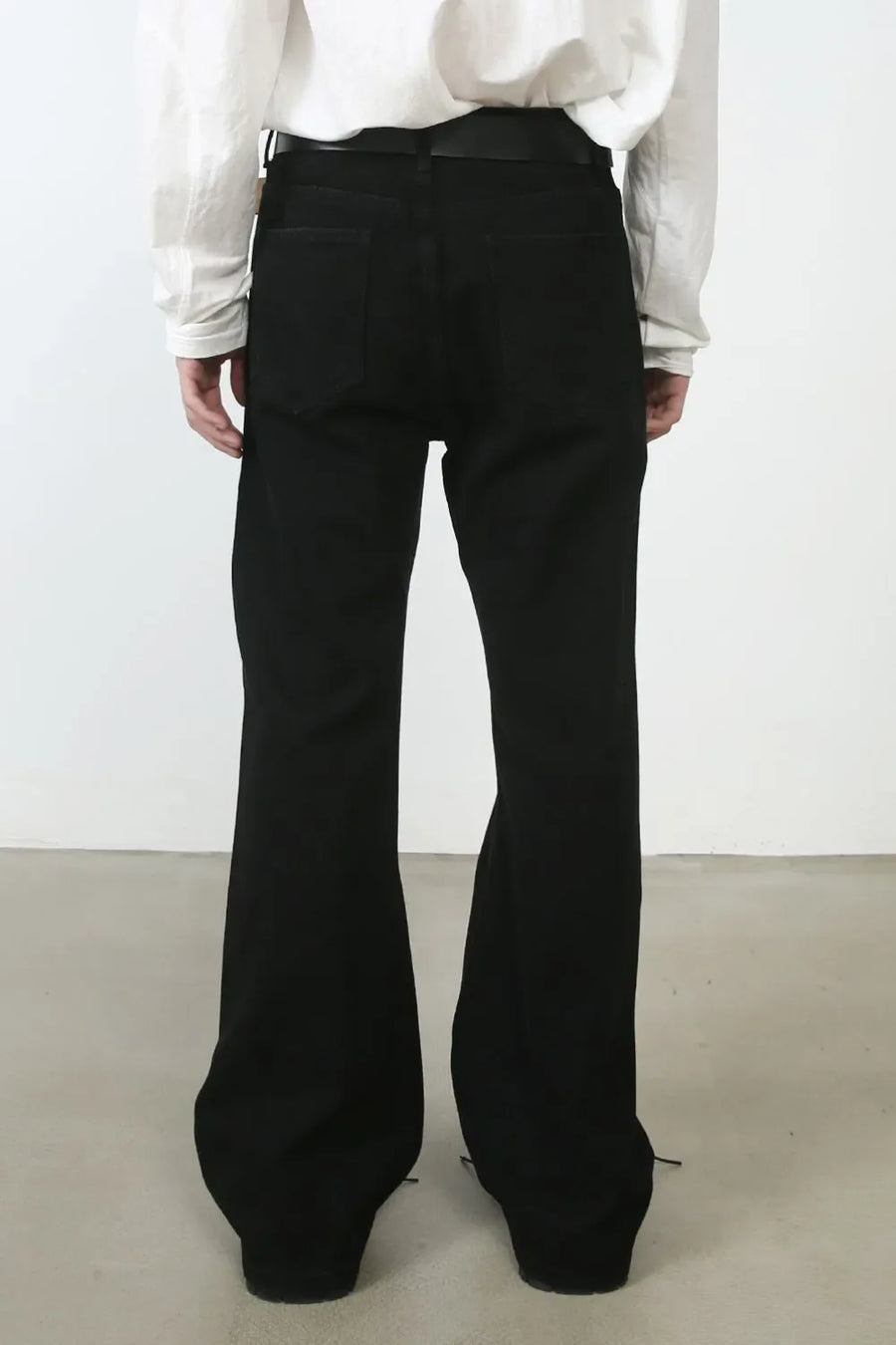 Black denim trousers with flared legs and seam detail