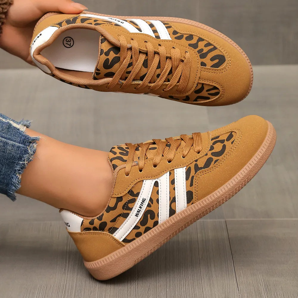 Leopard print walking sneakers with white stripes and lace-up closure.