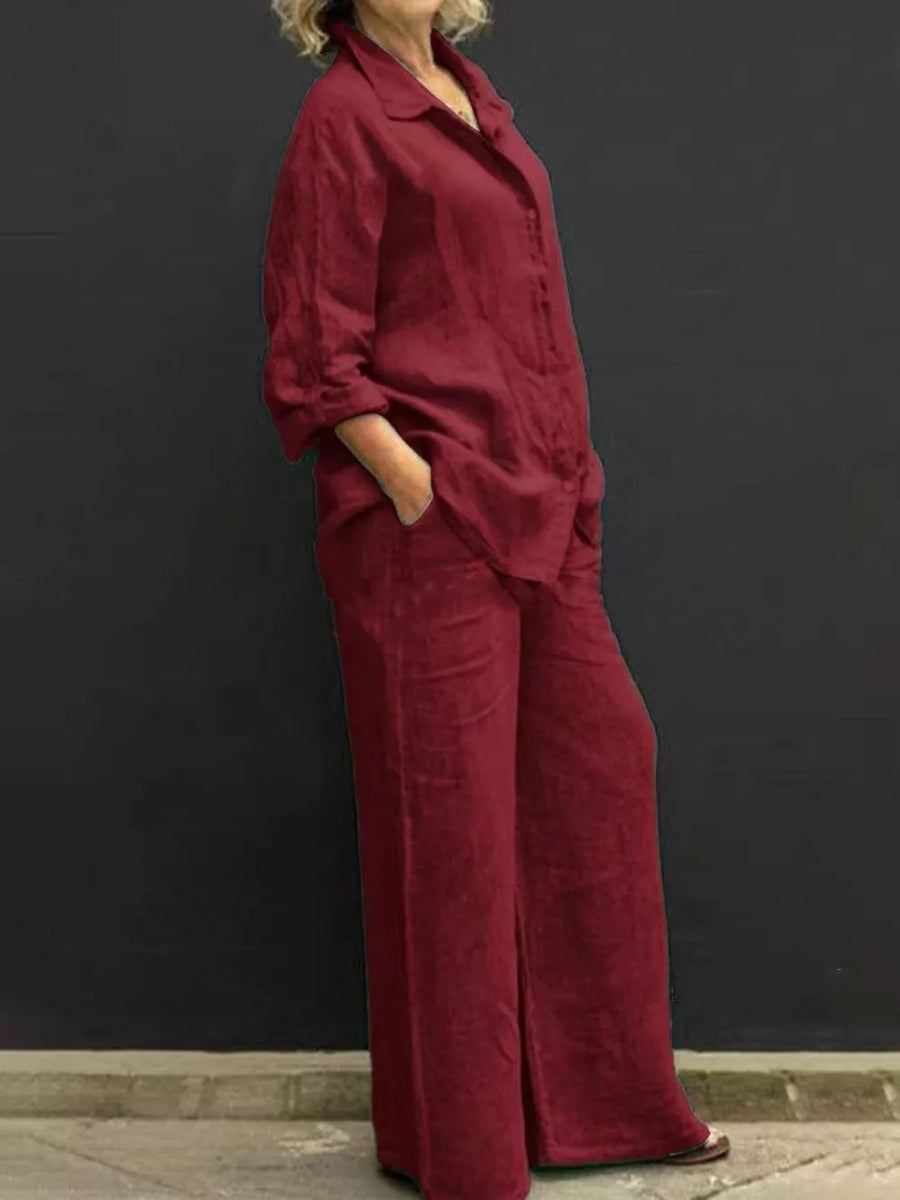 Relaxed two-piece set in wine red with buttoned collared top and wide-leg pants.