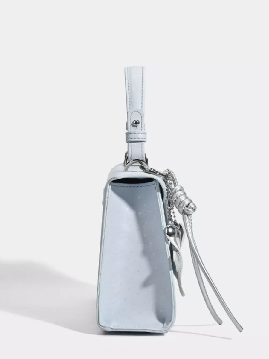 Chic mini pu leather tote in blue with silver buckle detail and charm.
