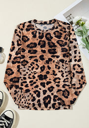 Sheer leopard print long sleeve blouse with a crew neck.