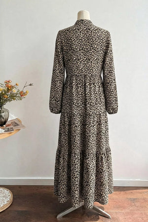 Chic midi dress with animal print, balloon sleeves, and tiered skirt.