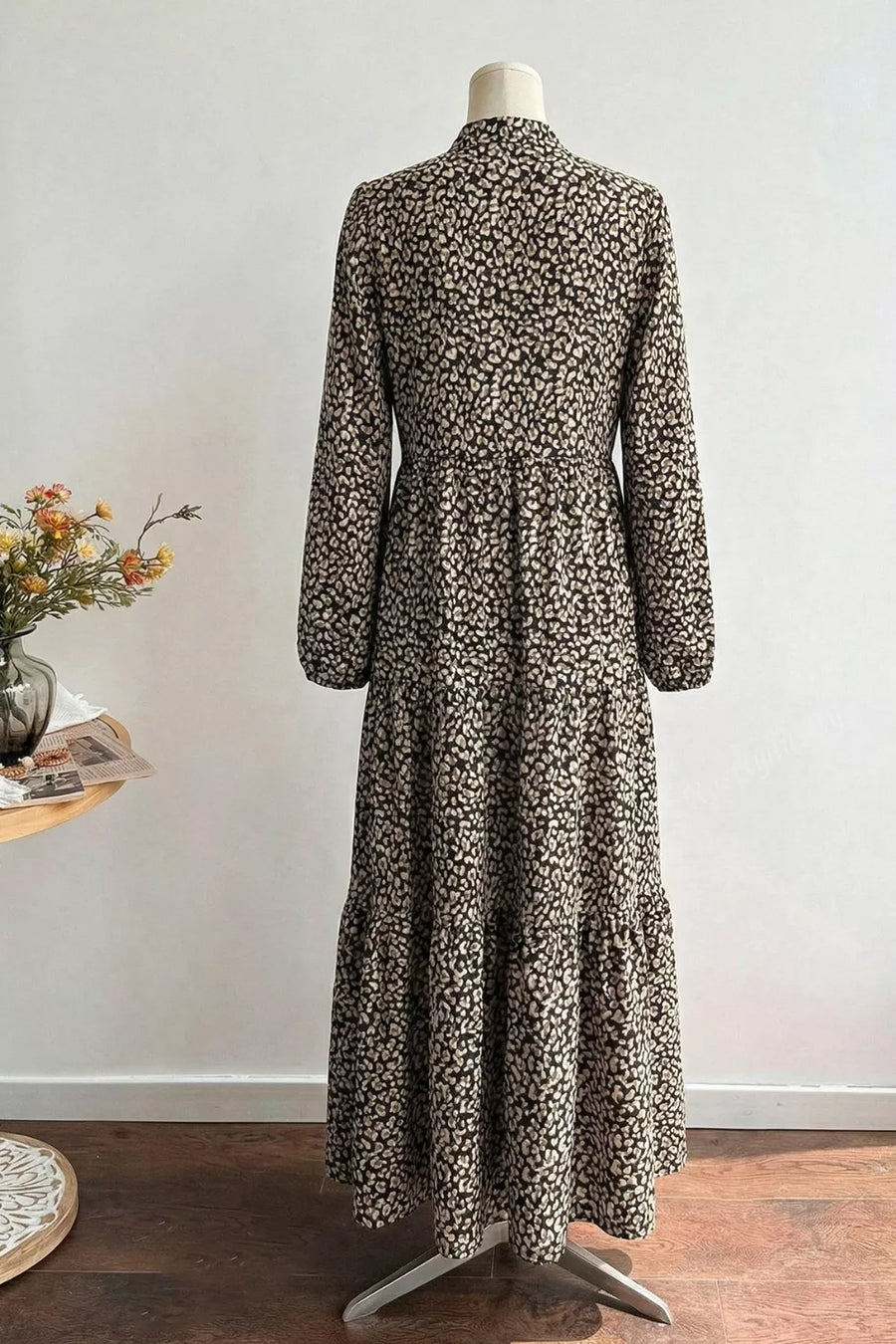 Chic midi dress with animal print, balloon sleeves, and tiered skirt.