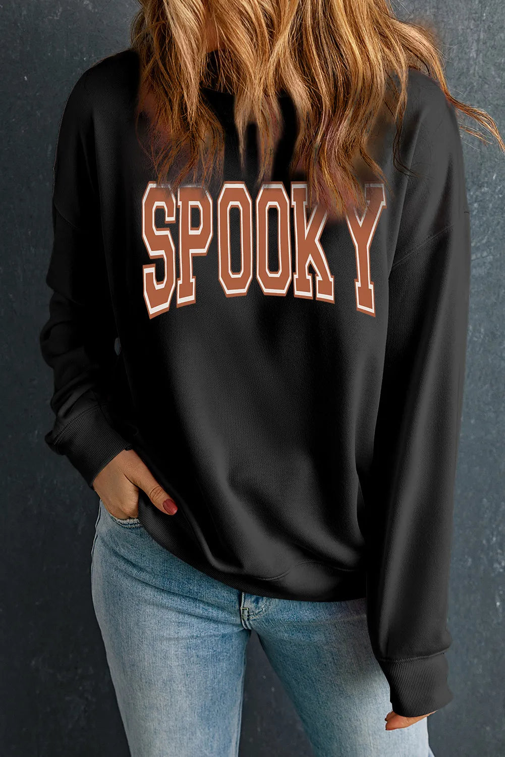 Black sweatshirt with varsity style SPOOKY graphic and ribbed cuffs.