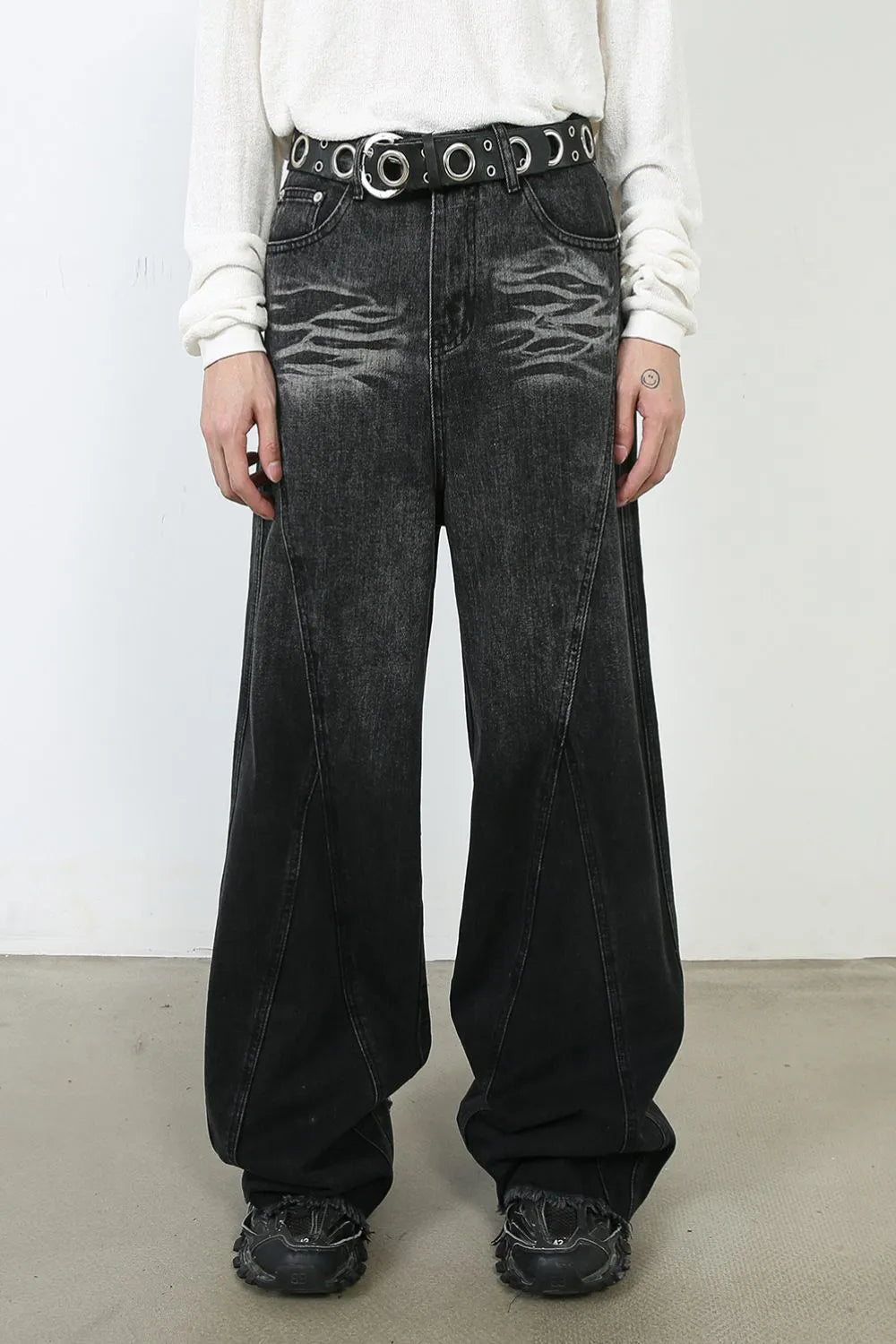 Sculpted dark denim palazzo trousers with a wide leg and distressed detailing.