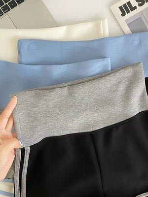 Black jogger shorts with gray contrast trim and side stripes.