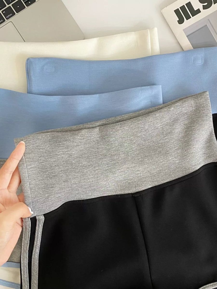 Black jogger shorts with gray contrast trim and side stripes.