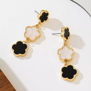 black earrings featuring drop design and clover