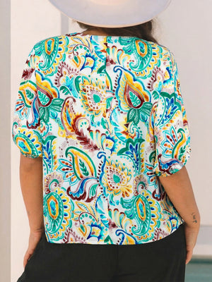 Paisley floral puff sleeve blouse with a V-neck and short sleeves in white with multicolor print.