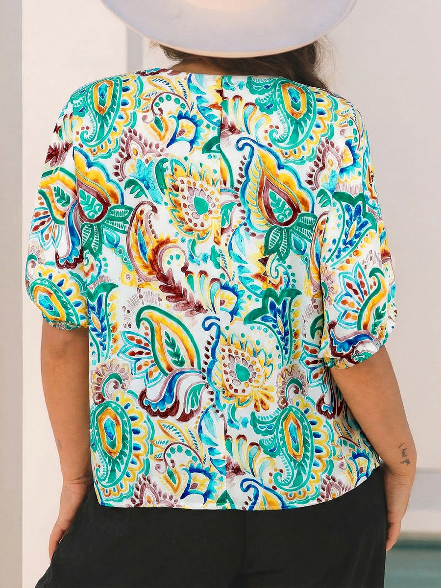 Paisley floral puff sleeve blouse with a V-neck and short sleeves in white with multicolor print.