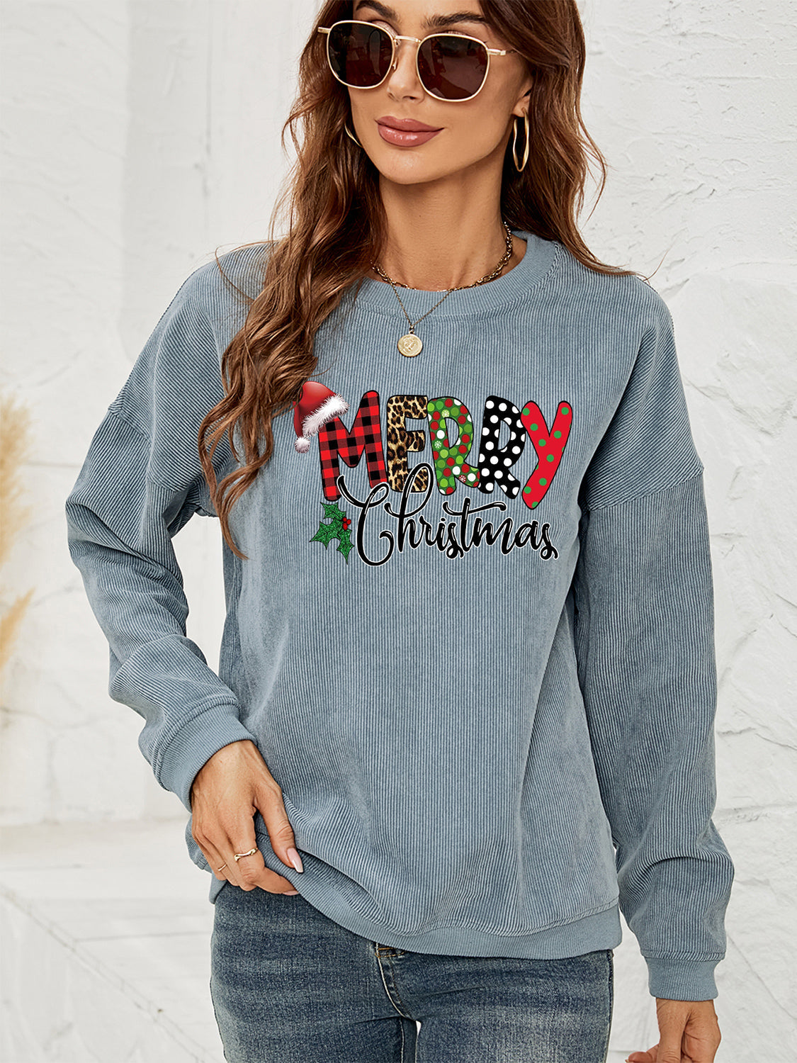Textured corduroy sweatshirt in Misty Blue with Merry Christmas graphic and Santa hat detail.