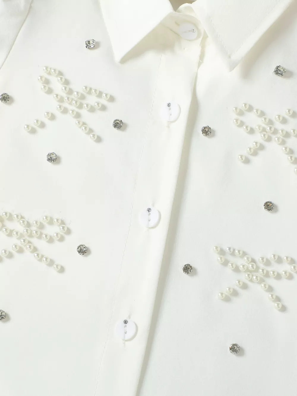 White button-up shirt with pearl and rhinestone bow embellishments
