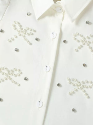 White button-up shirt with pearl and rhinestone bow embellishments
