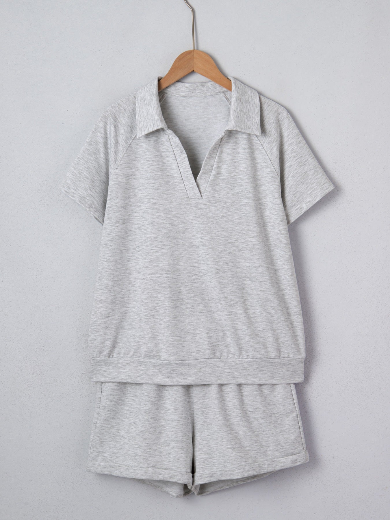 Grey polo collar loungewear set with short sleeves and shorts made of polyester.