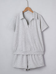 Grey polo collar loungewear set with short sleeves and shorts made of polyester.