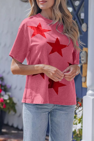 Festive star print mineral wash tee in pink, 100% cotton, with a crew neck and short sleeves.