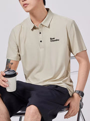 Apricot short-sleeve cotton polo shirt with button detail and embroidered text.