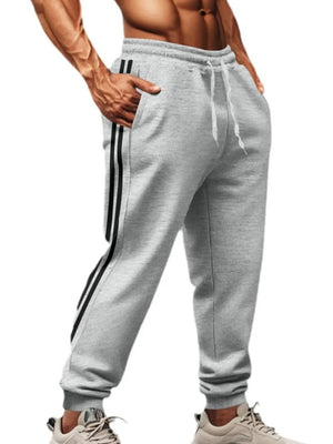 Gray joggers with black athletic stripes on the side, drawstring waist, and pockets.