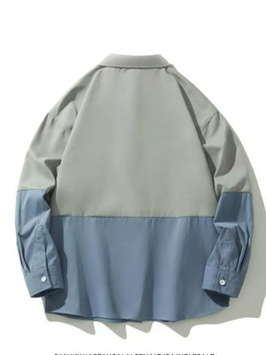 Two-tone oversized casual button-down shirt in French blue and grey with buttoned cuffs.