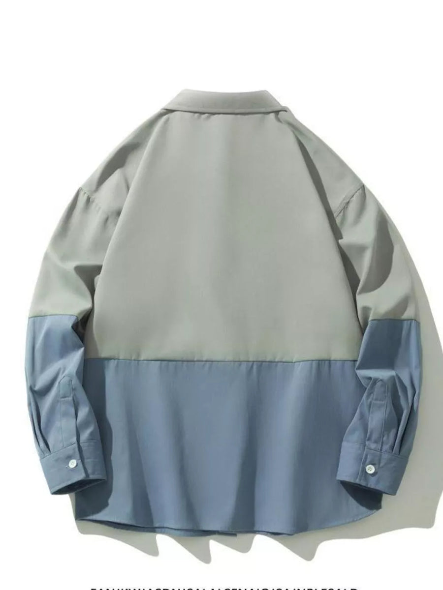 Two-tone oversized casual button-down shirt in French blue and grey with buttoned cuffs.