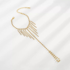 Gold rhinestone fringe hand chain bracelet with adjustable clasp and chain.