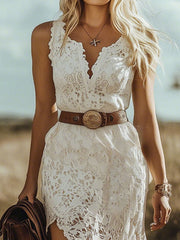 White lace sleeveless dress with asymmetrical hem and V-neckline.