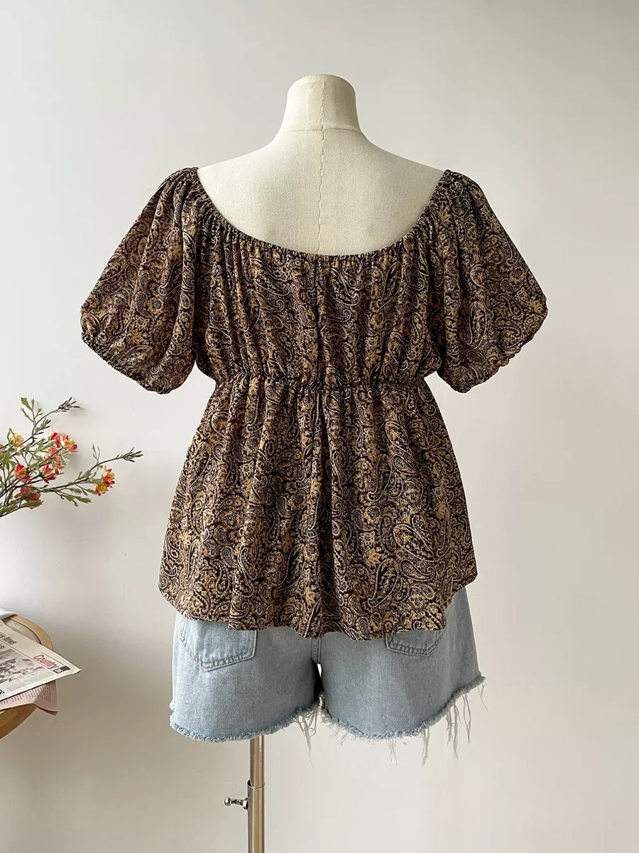 Plus size coffee brown paisley print drapey blouse with smocked waist and puff sleeves.