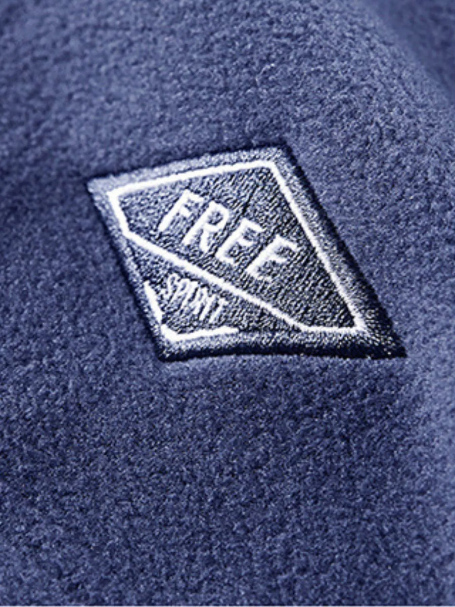 Men's blue fleece quarter zip sweatshirt with embroidered patch detail.