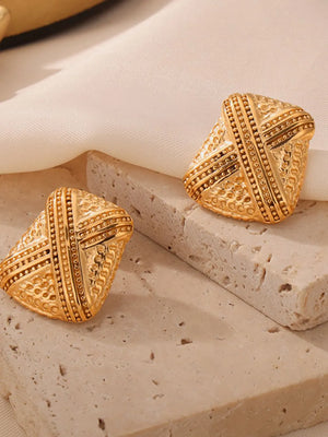 Sculptural gold-tone earrings with intricate embossed patterns and beaded trim.