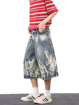 Men's wide-leg denim shorts with abstract bleach pattern and pockets.