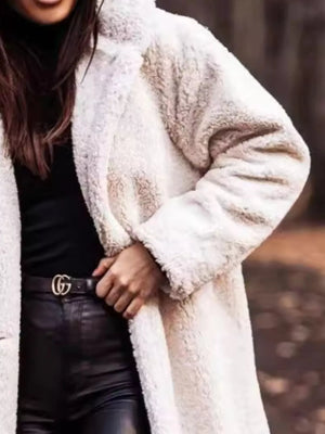 Creamy-white teddy bear longline coat with textured faux fur, styled with black leather pants.