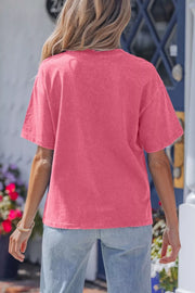 Pink mineral wash cotton tee with short sleeves and crew neck, featuring a subtle star print.