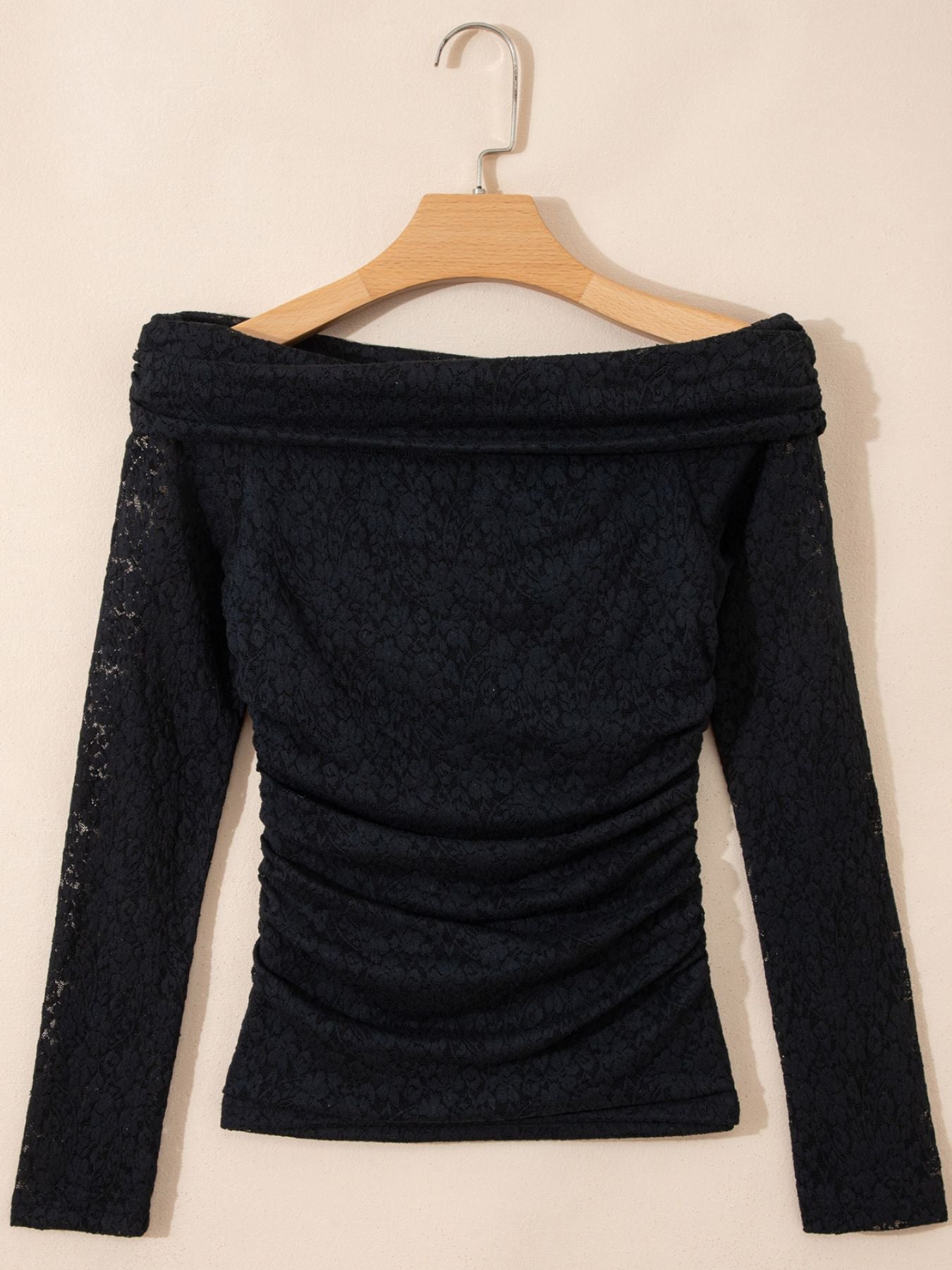 Black lace off-shoulder slim shirt with ruched sides and long sleeves.
