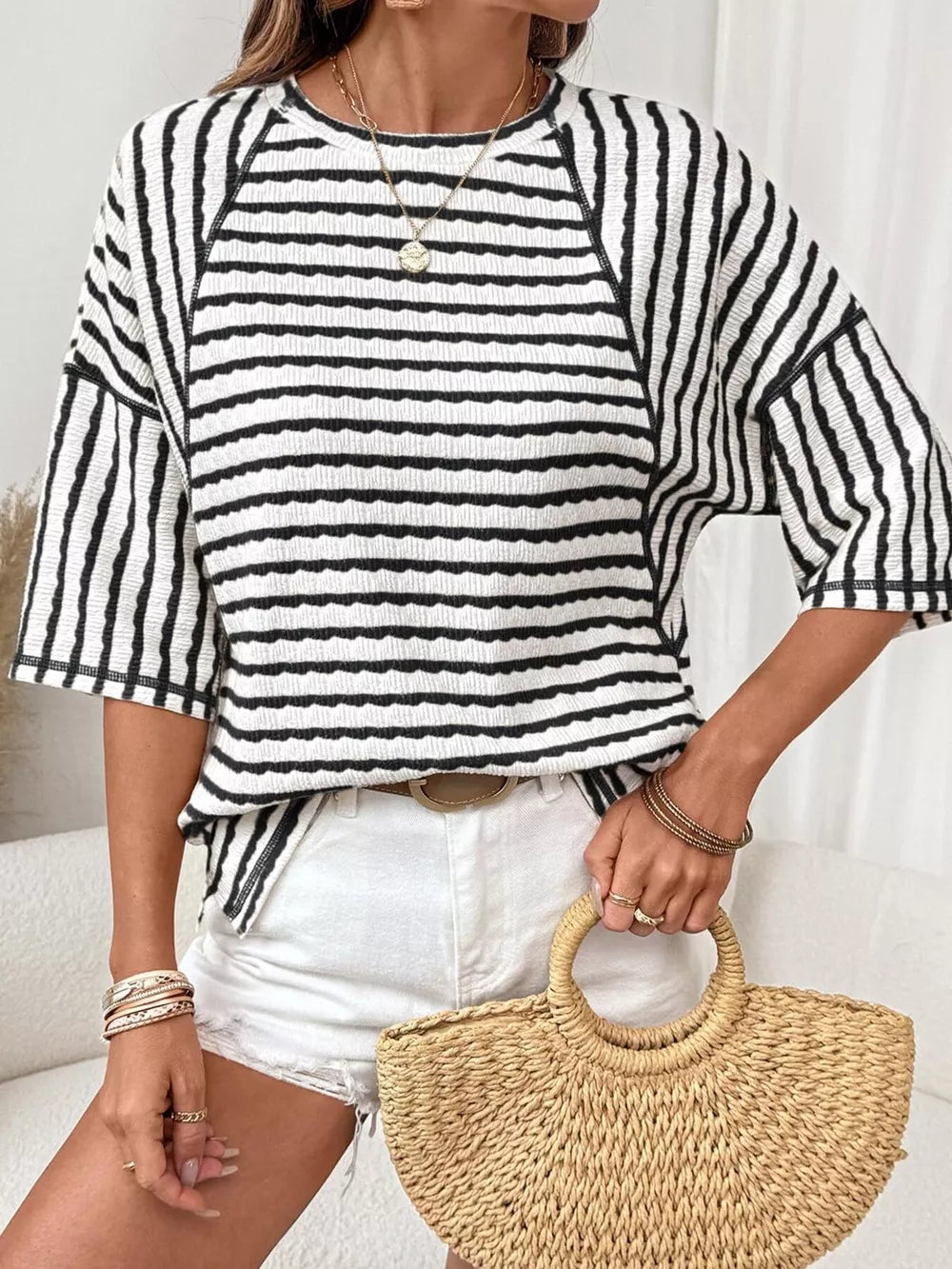 white t-shirt featuring seam detail and striped