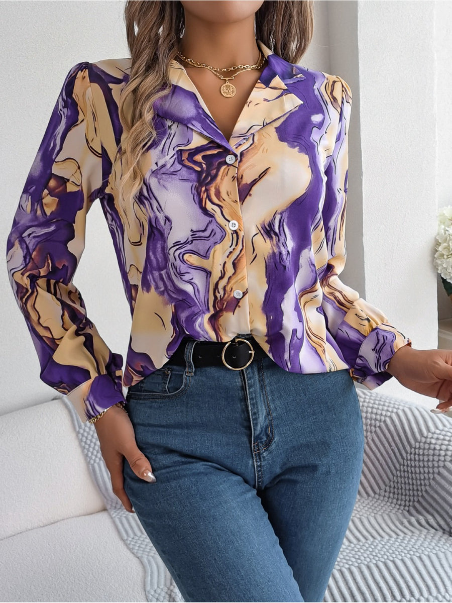 Women's abstract swirl print silk blouse with button front and long sleeves.