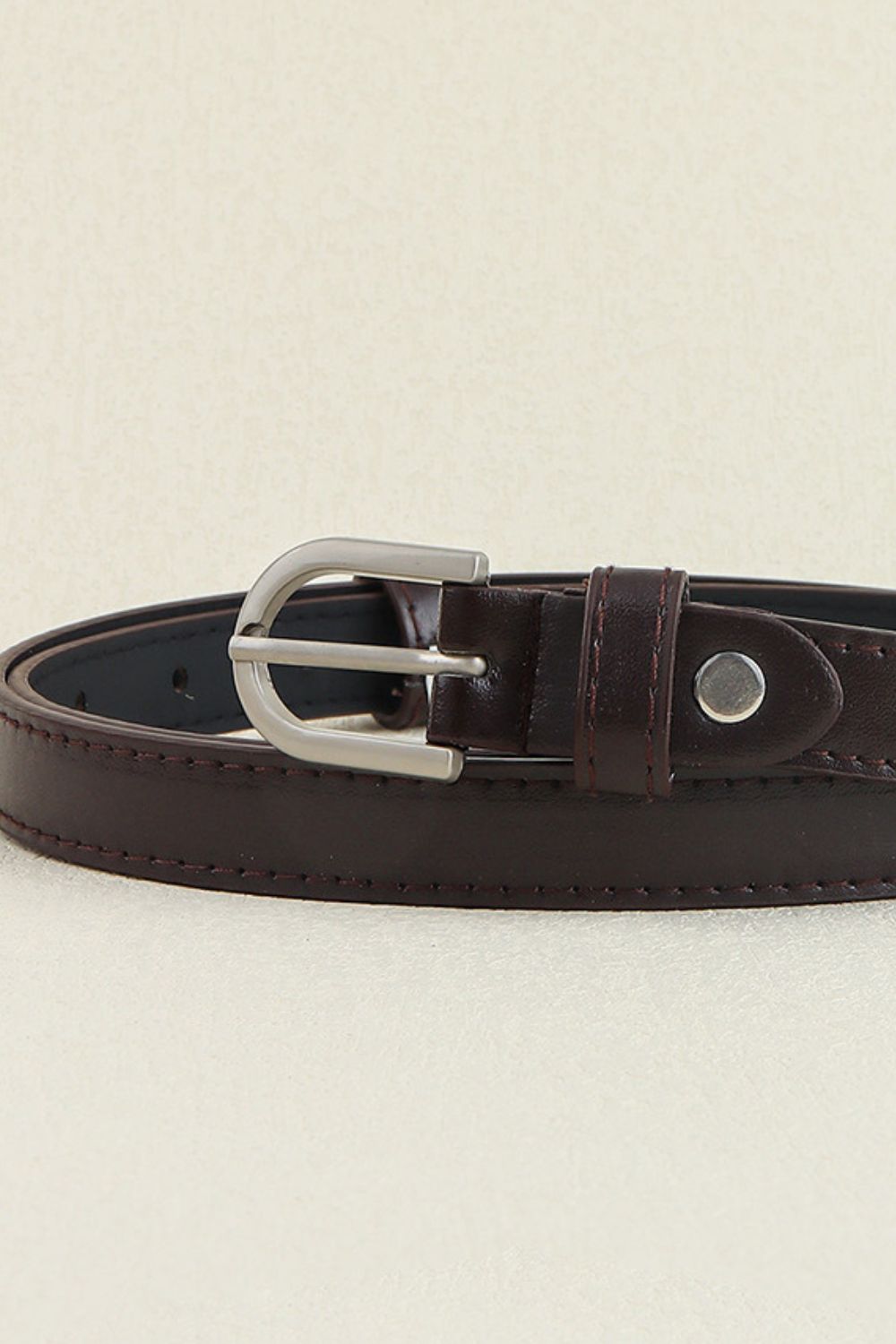 Slimline chocolate leatherette belt with silver buckle and stitched detail