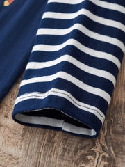 Dark navy and white striped long-sleeve baby tee with a graphic detail on the chest.