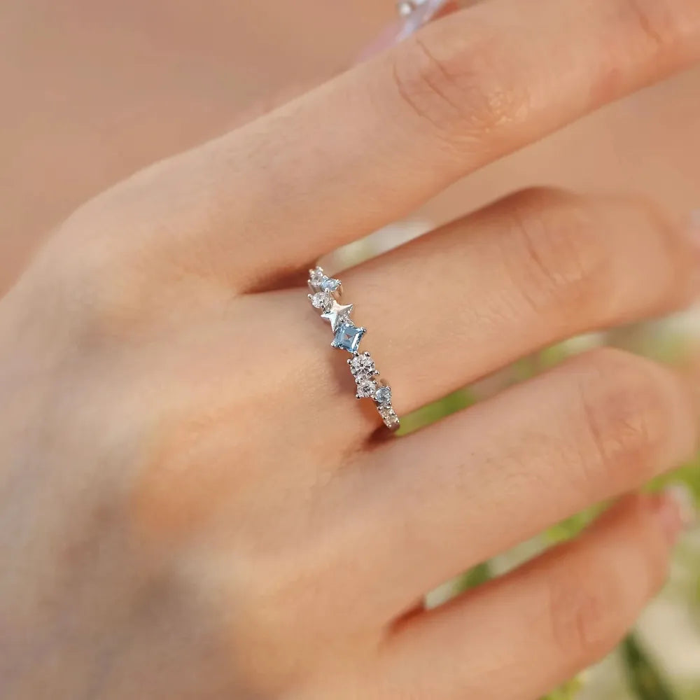 Silver ring with celestial cluster of blue and clear zircon stones.