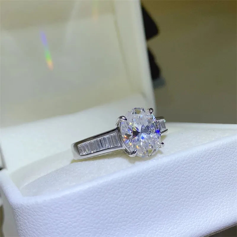 Silver oval cut diamond ring with baguette accents on band