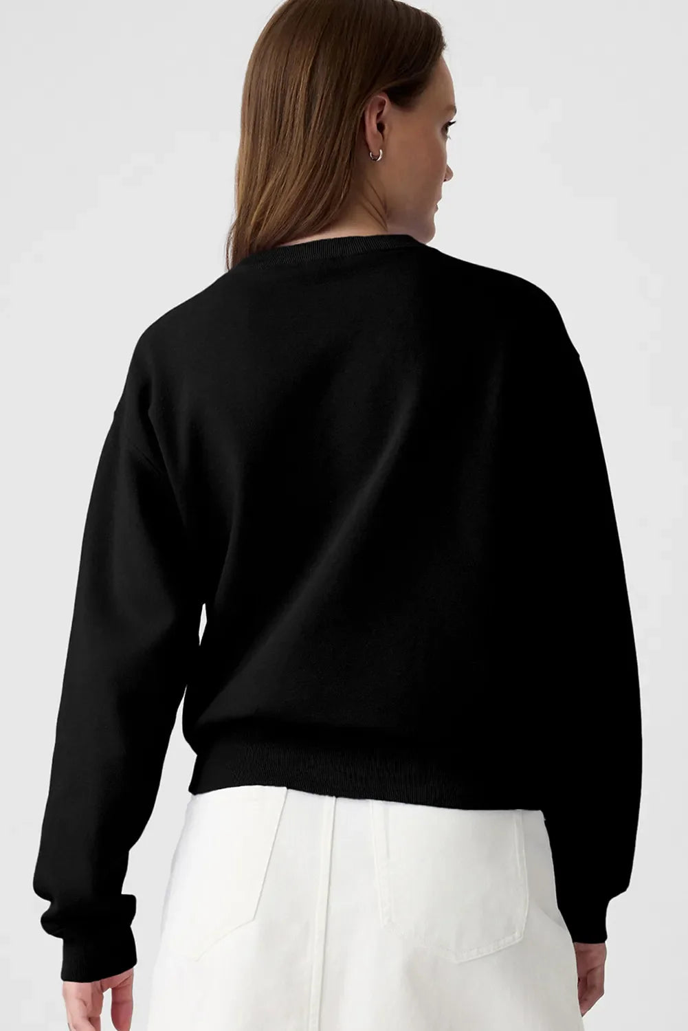 Black crewneck sweatshirt with a graphic print on the back.